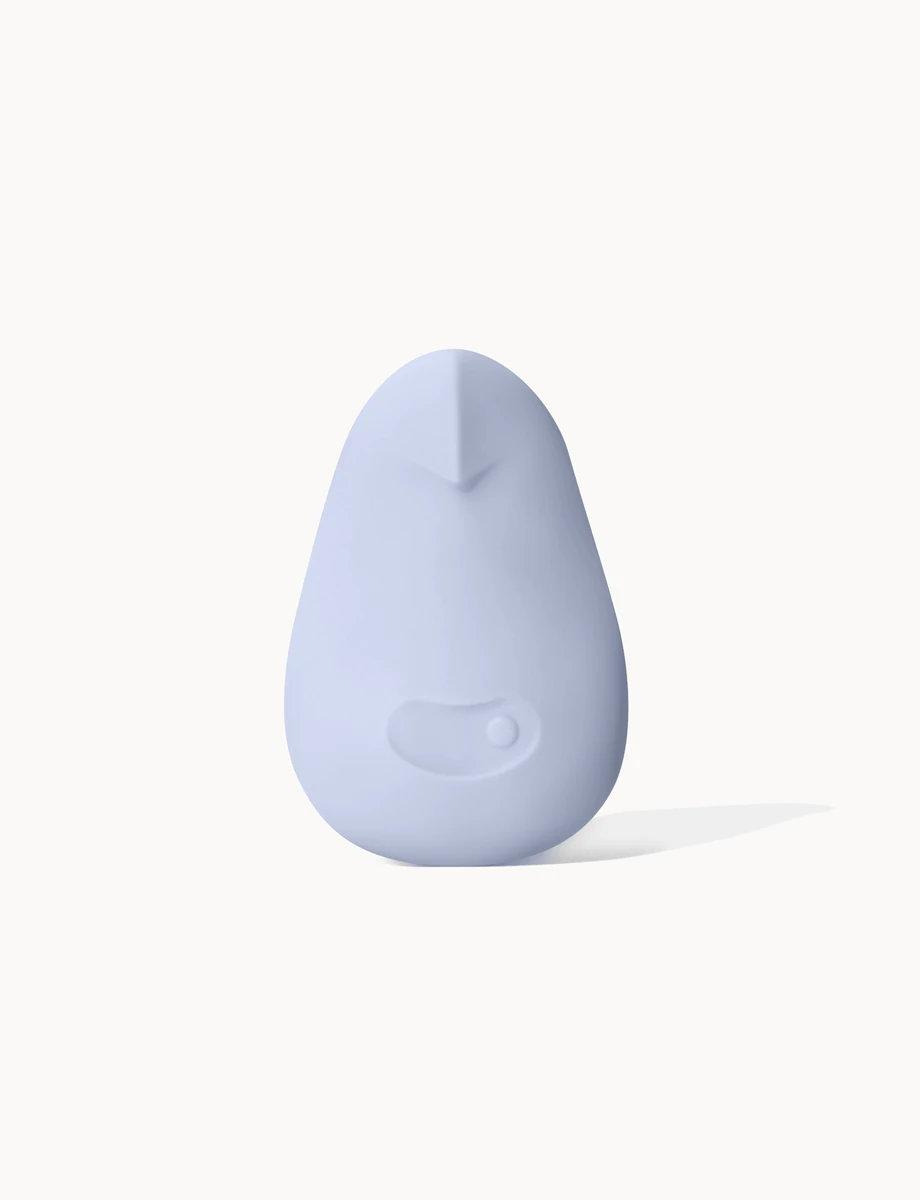 Official Dame Pom in Ice. Soft palm vibrator standing on a light background.