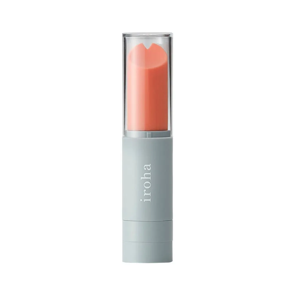 iroha stick lipstick vibrator in coral and gray with its clear cap on.