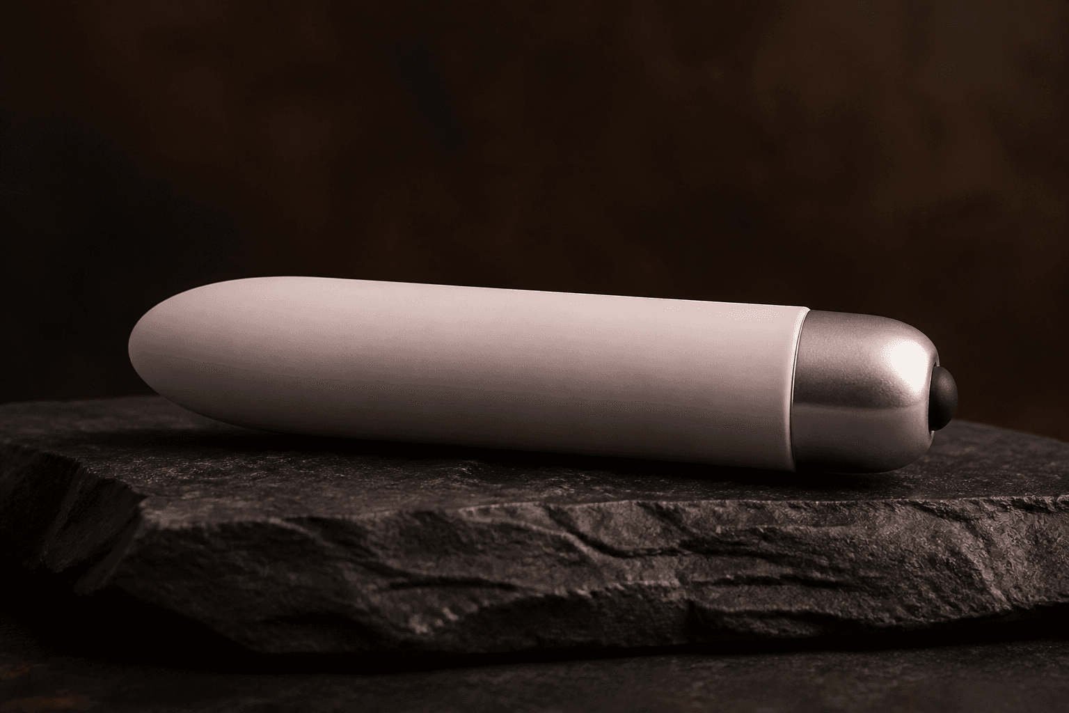 Editorial sample. Slim rose-sleeved bullet massager on dark stone.