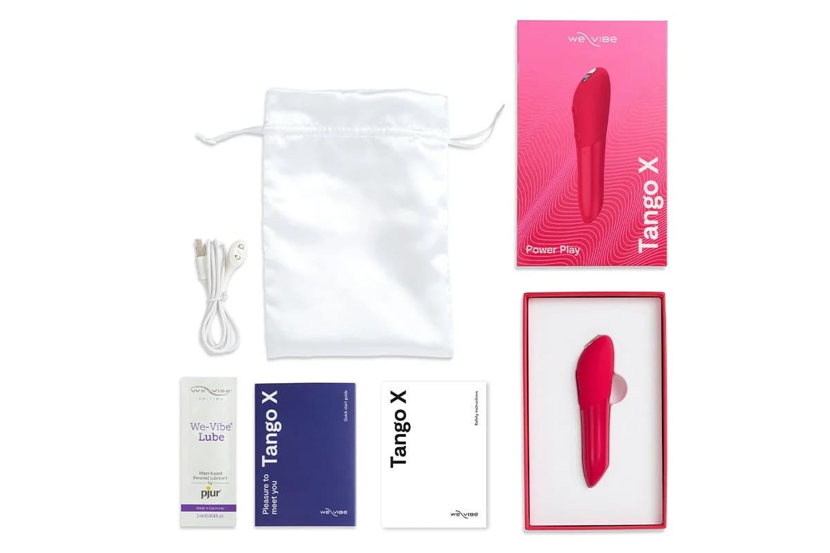 Official We-Vibe Tango X kit. Pink lipstick-size bullet with pouch, cable, and box on white.