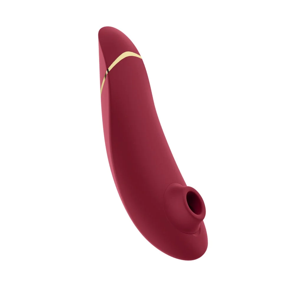 Official Womanizer Premium 2 in Bordeaux. Curved air-pulse stimulator with a circular silicone head on white.